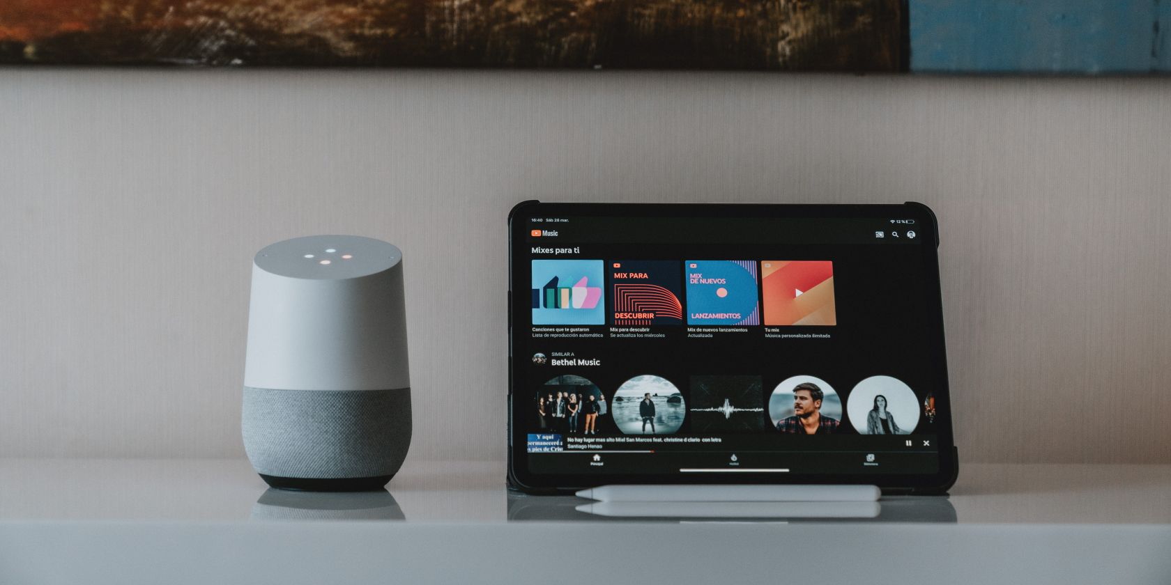 Google Home speaker next to iPad on a table